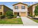 Charming townhome with a one car garage, manicured landscaping, and neutral color palette at 4528 Winding River Way, Land O Lakes, FL 34639