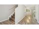 Hallway with modern floors, staircase, and neutral paint leading to the living space at 4528 Winding River Way, Land O Lakes, FL 34639