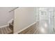 Hallway with modern floors, staircase, and neutral paint at 4528 Winding River Way, Land O Lakes, FL 34639