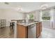 Updated kitchen with breakfast bar, stainless steel dishwasher, and granite countertops at 4528 Winding River Way, Land O Lakes, FL 34639