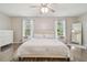 Light-filled main bedroom has modern flooring, neutral tones, and large mirror at 4528 Winding River Way, Land O Lakes, FL 34639