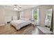 Bright main bedroom with hardwood floors, natural light, and neutral colors at 4528 Winding River Way, Land O Lakes, FL 34639