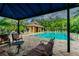Inviting community pool with lounge seating and covered area, perfect for leisure and relaxation at 4528 Winding River Way, Land O Lakes, FL 34639