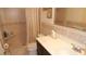 A bathroom with a dark vanity, white countertop, tiled walls and a shower with a curtain at 4744 Azalea Dr # 203B, New Port Richey, FL 34652