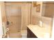 A bathroom with a dark vanity, white countertop, tiled walls and a shower with a curtain at 4744 Azalea Dr # 203B, New Port Richey, FL 34652