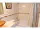 Bright bathroom features tiled walls, framed art, shower-tub, and modern fixtures at 4744 Azalea Dr # 203B, New Port Richey, FL 34652