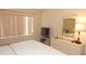 Neutral bedroom with natural lighting featuring a television, dresser, and teddy bear collection at 4744 Azalea Dr # 203B, New Port Richey, FL 34652