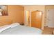 A cozy bedroom featuring a double bed, an armoire, and a door leading to a bathroom at 4744 Azalea Dr # 203B, New Port Richey, FL 34652