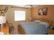 A bedroom with a neutral palette, ceiling fan, and a window providing natural light at 4744 Azalea Dr # 203B, New Port Richey, FL 34652