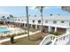 Community pool with lounge chairs and condo units with outdoor balconies at 4744 Azalea Dr # 203B, New Port Richey, FL 34652