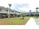 Beautiful two-story condo building featuring well-maintained landscaping and a meticulously manicured lawn at 4744 Azalea Dr # 203B, New Port Richey, FL 34652
