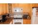 Bright kitchen with stainless steel appliances, granite counters, and wooden cabinets at 4744 Azalea Dr # 203B, New Port Richey, FL 34652