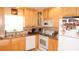 Bright kitchen with stainless steel appliances, granite counters, and wooden cabinets at 4744 Azalea Dr # 203B, New Port Richey, FL 34652