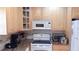 Kitchen features stainless steel appliances, wood cabinets, and light granite countertops at 4744 Azalea Dr # 203B, New Port Richey, FL 34652