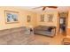 Cozy living room featuring comfortable seating, a ceiling fan, and plenty of natural light at 4744 Azalea Dr # 203B, New Port Richey, FL 34652