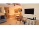 Open floor plan showcasing a flat screen TV with chair seating and dining space at 4744 Azalea Dr # 203B, New Port Richey, FL 34652