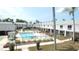 Aerial view of a community pool with lounge chairs and manicured grounds at 4744 Azalea Dr # 203B, New Port Richey, FL 34652