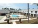 Aerial view of a community pool with lounge chairs and manicured grounds at 4744 Azalea Dr # 203B, New Port Richey, FL 34652