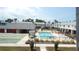 Community pool with lounge chairs and meticulously maintained shuffleboard court at 4744 Azalea Dr # 203B, New Port Richey, FL 34652