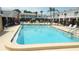 Inviting community pool with clear blue water, surrounded by ample seating for relaxation and socializing at 4744 Azalea Dr # 203B, New Port Richey, FL 34652