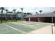 Well maintained shuffleboard courts and clubhouse under a sunny sky, perfect for community enjoyment at 4744 Azalea Dr # 203B, New Port Richey, FL 34652