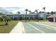 Scenic view of shuffleboard courts with manicured lawns and lush tropical trees in the community at 4744 Azalea Dr # 203B, New Port Richey, FL 34652