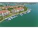 Aerial view showcasing condos with private boat slips, offering direct access to the open water at 511 Sandy Hook Rd, Treasure Island, FL 33706