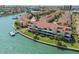 Stunning aerial view of waterfront condos with boat docks, offering luxurious coastal living at 511 Sandy Hook Rd, Treasure Island, FL 33706