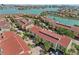 Expansive aerial view of waterfront condos with pools, lush landscaping, and convenient parking at 511 Sandy Hook Rd, Treasure Island, FL 33706