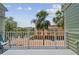 Balcony with seating and views of palm trees and neighboring buildings at 511 Sandy Hook Rd, Treasure Island, FL 33706