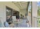 Charming balcony with seating, table, outdoor rug, and sliding glass doors providing plenty of natural light at 511 Sandy Hook Rd, Treasure Island, FL 33706