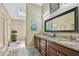 The bathroom is spacious and bright, with a skylight and a granite countertop at 511 Sandy Hook Rd, Treasure Island, FL 33706