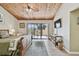 Comfortable bedroom with wood ceiling, a ceiling fan, balcony access, and a TV for relaxing evenings at 511 Sandy Hook Rd, Treasure Island, FL 33706