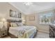 Bedroom featuring attractive bed and furnishings and a window with tree views at 511 Sandy Hook Rd, Treasure Island, FL 33706