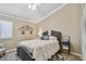Cozy bedroom with a decorative comforter, attractive rug and a ceiling fan at 511 Sandy Hook Rd, Treasure Island, FL 33706