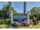Entrance to Village of Paradise Island with beautiful landscaping and lush tropical foliage at 511 Sandy Hook Rd, Treasure Island, FL 33706