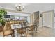 Open dining room with stylish table set and easy access to the modern kitchen with bar seating at 511 Sandy Hook Rd, Treasure Island, FL 33706