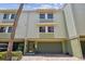 Multi-story townhome featuring an attached garage, charming exterior, and a welcoming entrance at 511 Sandy Hook Rd, Treasure Island, FL 33706