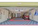 Garage featuring a golf cart and storage space in a well-lit area at 511 Sandy Hook Rd, Treasure Island, FL 33706