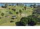 Aerial view of a well-maintained golf course with palm trees and waterfront views, great for leisure at 511 Sandy Hook Rd, Treasure Island, FL 33706