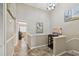 Hallway with decorative tile and art leads to an open living space with a staircase at 511 Sandy Hook Rd, Treasure Island, FL 33706