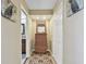 Hallway features a wicker dresser with a mirror, closet space, and access to the bathroom at 511 Sandy Hook Rd, Treasure Island, FL 33706