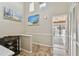 Hallway featuring coastal-themed artwork, tiled floors, and access to the balcony for a relaxing atmosphere at 511 Sandy Hook Rd, Treasure Island, FL 33706