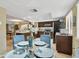 Inviting kitchen with stainless steel appliances, stone countertops, and a breakfast table for casual dining at 511 Sandy Hook Rd, Treasure Island, FL 33706