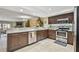 Updated kitchen with stainless steel appliances, stone countertops, open to living area, and tiled floors at 511 Sandy Hook Rd, Treasure Island, FL 33706