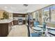 Modern kitchen includes stainless steel appliances, stone countertops, and a breakfast table near the window at 511 Sandy Hook Rd, Treasure Island, FL 33706