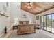Beautiful main bedroom with wood-paneled ceiling and ceiling fan, opens onto a private balcony at 511 Sandy Hook Rd, Treasure Island, FL 33706