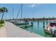 Scenic waterfront featuring a dock and boats, complemented by views of the surrounding buildings at 511 Sandy Hook Rd, Treasure Island, FL 33706
