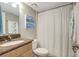 Cozy bathroom featuring granite vanity, a white shower curtain, and charming décor at 5582 Baywater Dr, Tampa, FL 33615