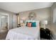 Charming bedroom with a sunburst mirror, comfortable bed, and ensuite bathroom at 5582 Baywater Dr, Tampa, FL 33615